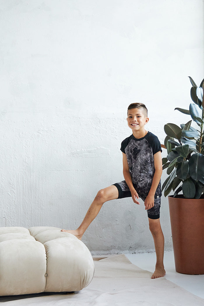 Marcus is 8 years old, 4'7" tall and is wearing a size 7/8