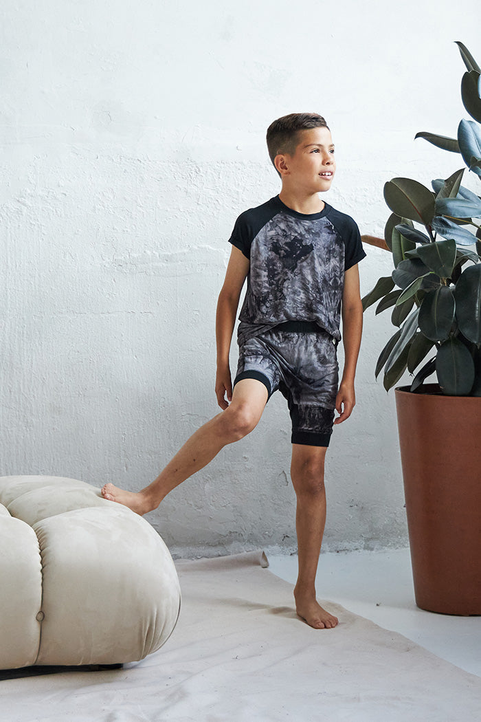 Marcus is 8 years old, 4'7" tall and is wearing a size 7/8